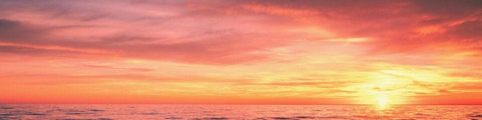 Wall Mural - Seascape in the evening. Sunset over the sea. Dramatic sky. Horizontal banner