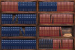Books on the bookshelves in the library. Dark wood bookcase.