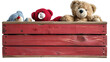 A red wooden toy box with some toys and a teddy bear on a transparent background. PNG format, This PNG file, with an isolated cutout object on a transparent background.