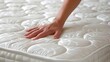 © Ilja - Woman s hands putting white fitted sheet on mattress in close up detail for bedding decor