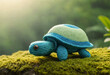 Knitted woolly turtle on a beautiful natural background, space for an inscription