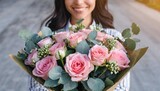 very nice young woman holding big and beautiful bouquet of fresh ohara roses smaller roses eucalyptus eustoma in tender pink colors cropped photo bouquet close up
