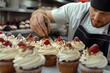 Delightful cupcakes are decorated by a male pastry chef. Generative Ai.