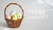 Happy Easter! - Easter basket with eggs on a white background, inscription Happy Easter!