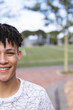 © Wavebreak Media - Teenage biracial boy smiles outdoors, with copy space