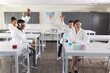 © Wavebreak Media - Diverse students celebrate in a science lab, with copy space