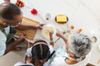 © Wavebreak Media - Biracial grandparents and granddaughter prepare pancakes together at home