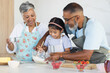 © Wavebreak Media - Biracial grandparents and granddaughter enjoy baking together in a home kitchen