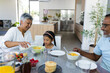 © Wavebreak Media - Biracial grandparents enjoy breakfast together at home