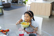 © Wavebreak Media - Biracial girl enjoys her breakfast at home, with copy space