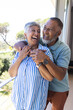 © Wavebreak Media - Senior biracial couple shares a joyful moment outdoors
