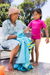 © Wavebreak Media - Biracial grandmother and granddaughter enjoy a sunny poolside day