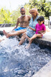© Wavebreak Media - Biracial grandparents and granddaughter enjoy a sunny day by the pool with copy space
