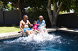 © Wavebreak Media - Biracial grandparents and granddaughter enjoy a sunny day by the pool
