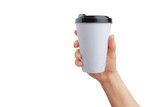Fototapeta Nowy Jork - Hand holds white paper cup for takeaway coffee transparent. Ideal surface for logo promotion and mockup. Perfect for branding and marketing projects