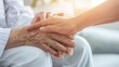 Elderly female hand holding hand of young caregiver at nursing home.Geriatric doctor or geriatrician concept. Doctor physician hand on happy elderly senior patient to comfort in hospital examination