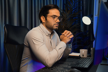 Working smart IT developer analyzing data software development on two pc screen, creating application program updated version online website page system online at neon light cyber office. Surmise.