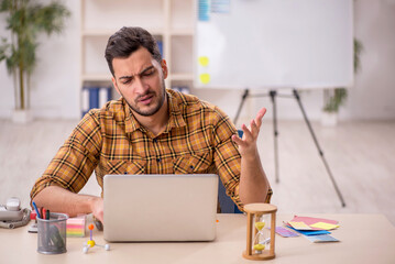 Wall Mural - Young male designer working in the office