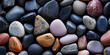 The smooth, polished texture of river stones, with each one worn smooth by the gentle caress of