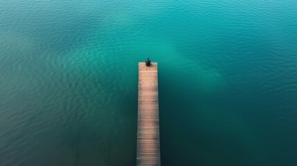 Wall Mural - aerial photography of a lone fisherman waiting patiently at the end of the wooden pier