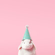 Happy Easter day, bunny with party hat on pastel pink background. 3d rendering