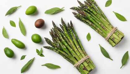 Wall Mural - Green herbs, asparagus and black avocado on a white background