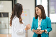 © Thitisak - Asian business woman working and talking at the office