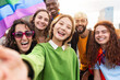 © EFStock - Asian woman taking selfie photo of diverse friends having fun with LGBT gay rainbow flags