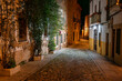 Lovely street at night with stone buildings and ivy on the walls, Caceres, Spain.