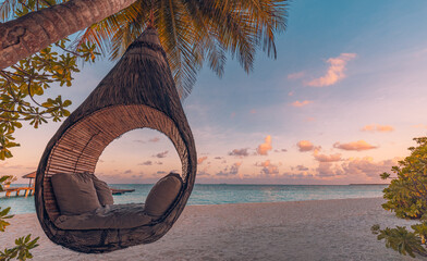 Beautiful silhouette of hammock on palm trees on tropical beach paradise at sunset. Carefree freedom concept, summer nature, exotic shore coast. Tranquil travel landscape. Enjoy life, positive energy
