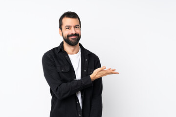 Wall Mural - Young man with beard over isolated white background presenting an idea while looking smiling towards