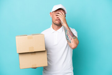 Wall Mural - Delivery caucasian man isolated on blue background with tired and sick expression