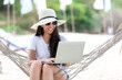 © freebird7977 - Lifestyle freelance woman using laptop working and relax on the beach.  Asian people success and together your work pastime and meeting conference on internet in holiday. Business and Summer Concept