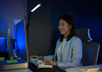 Poster - Portrait of young hardworking businesswoman working overtime during the night in her office room.