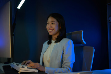 Poster - Portrait of young hardworking businesswoman working overtime during the night in her office room.