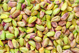 Fototapeta Mapy - Peeled pistachio nuts background texture