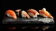 Sushi nigiri set on a stone plate over black background