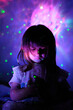 A little girl in the glow of starry light