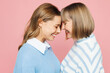 © ViDi Studio - Close up elder parent mom 50s year old with young adult daughter two women together wear blue casual clothes hug touch forehead head isolated on plain pastel light pink background. Family day concept.