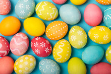 Easter Eggs On A Bright Blue Background. Easter Celebration Concept. Colorful Easter Handmade Decorated Easter Eggs. Place For Text. Copy Space.