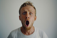 A Young Man With A Wide Mouth Open Looking Surprised And Shocked. 