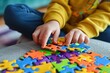 © Iryna - hands of an autistic child hold a colorful puzzle. World autism awareness day
