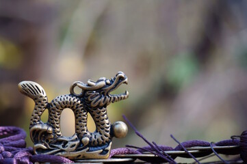 Wall Mural - A figurine of a Chinese dragon with Chinese coins. Horoscope and feng shui.