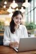 © Fotograf - A woman sitting in front of a laptop computer, suitable for illustrating remote work concept