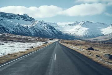 Leinwandbilder - A serene image of an empty road with majestic mountains in the background. Perfect for travel or nature-themed designs