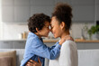 Loving moment as black mother and son share tender forehead touch