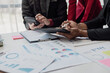© MrAshi - Business people meeting in a business presentation or seminar, documents, graphs and financial or marketing charts are There is a laptop and digital tablet on the table. Close-up shot
