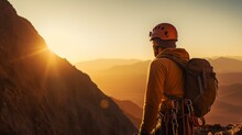 Climber In Protective Helmet Hanging On Mountain