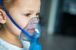 © dtatiana - Cute little girl are sitting and holding a nebulizer mask leaning against the face, airway treatment concept