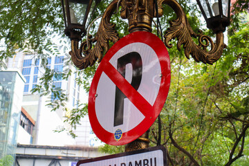 a no parking sign here. surabaya, indonesia - 21 february 2024